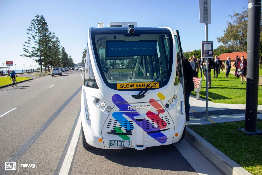 Exterior photo shows the front of the Newcastle Driverless Shuttle. 