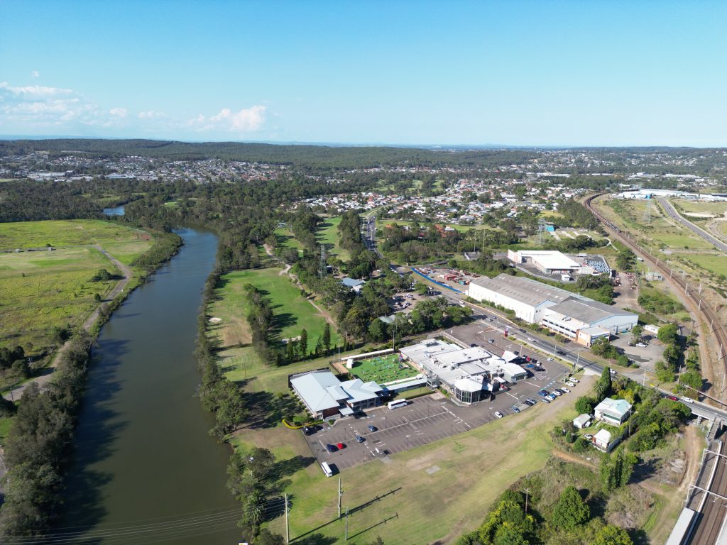 Drone shot shows Club Macquarie and Cockle Creek, looking in the general direction of Glendale.  